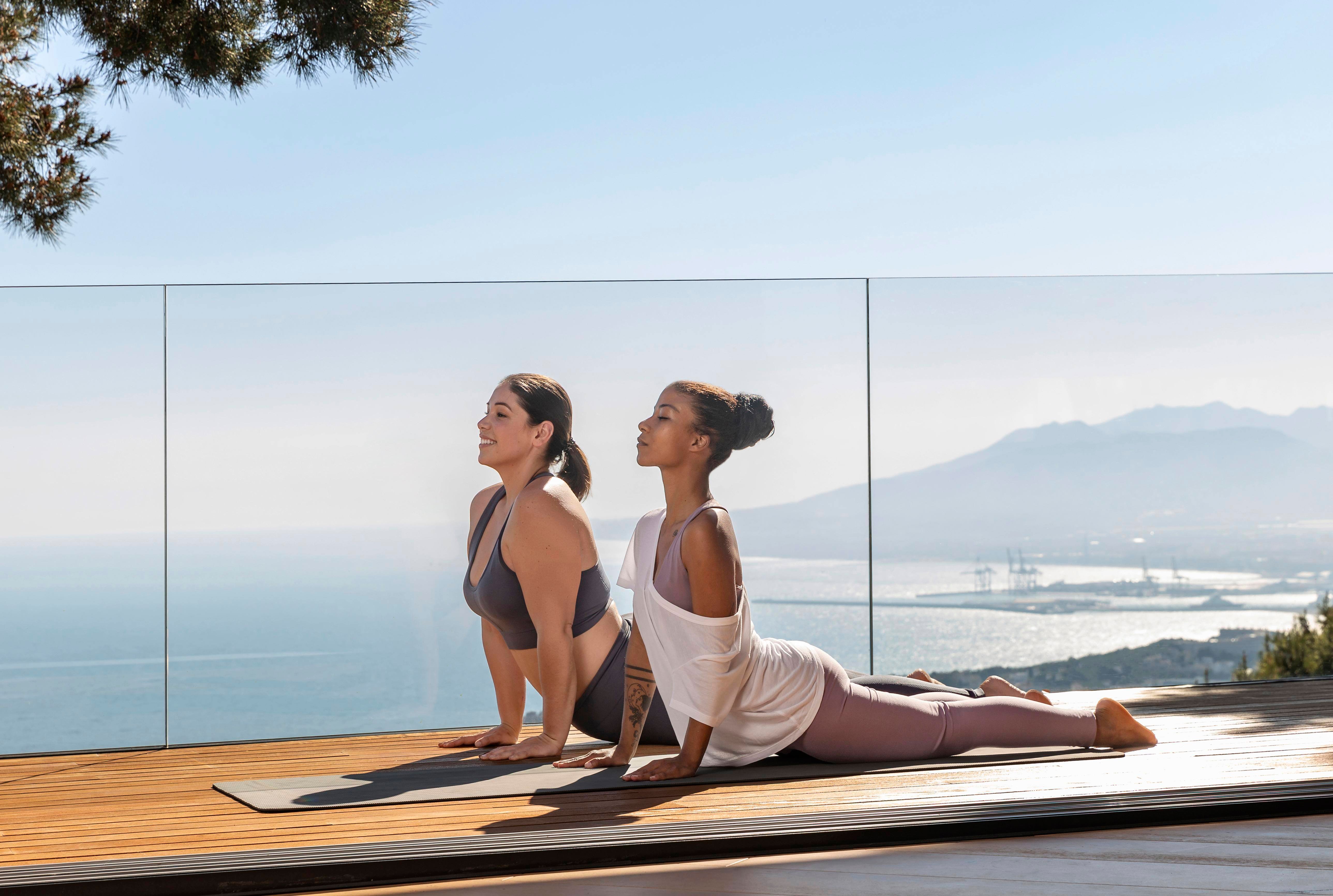 full-shot-woman-doing-yoga-with-teacher