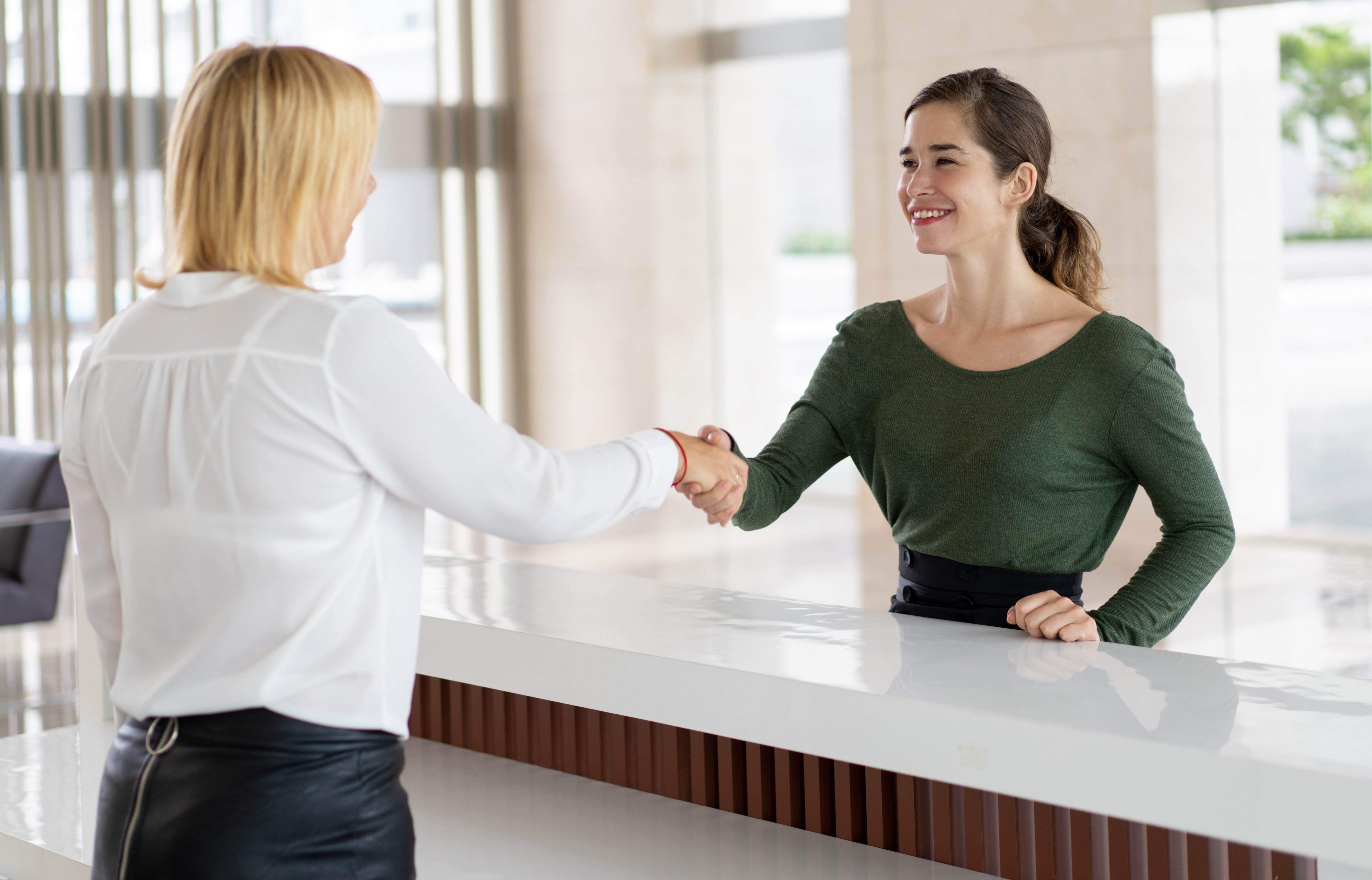 office-receptionist-greeting-corporate-partner