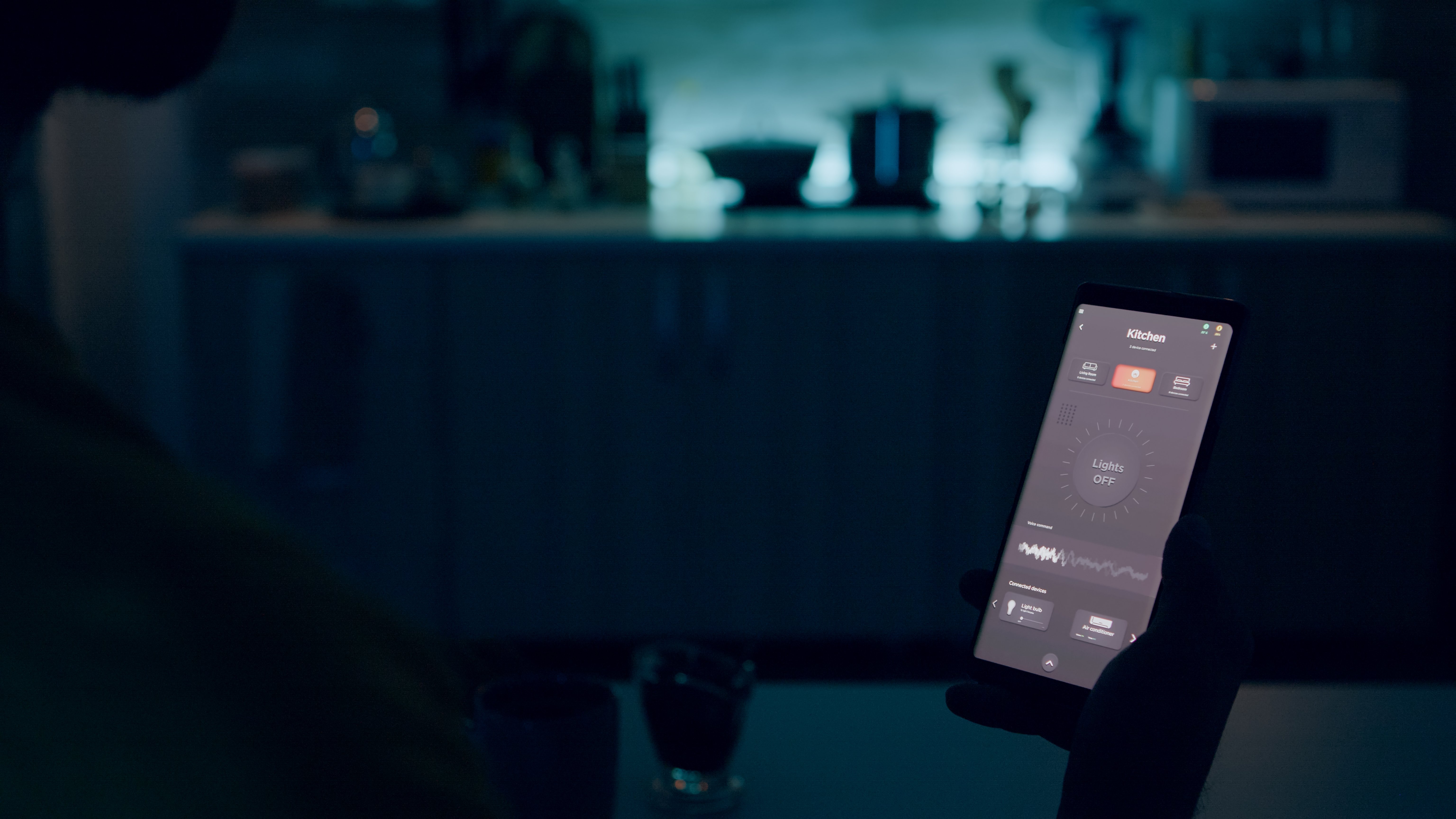 person-looking-smartphone-with-smart-home-lights-app-sitting-kitchen-house-with-automation