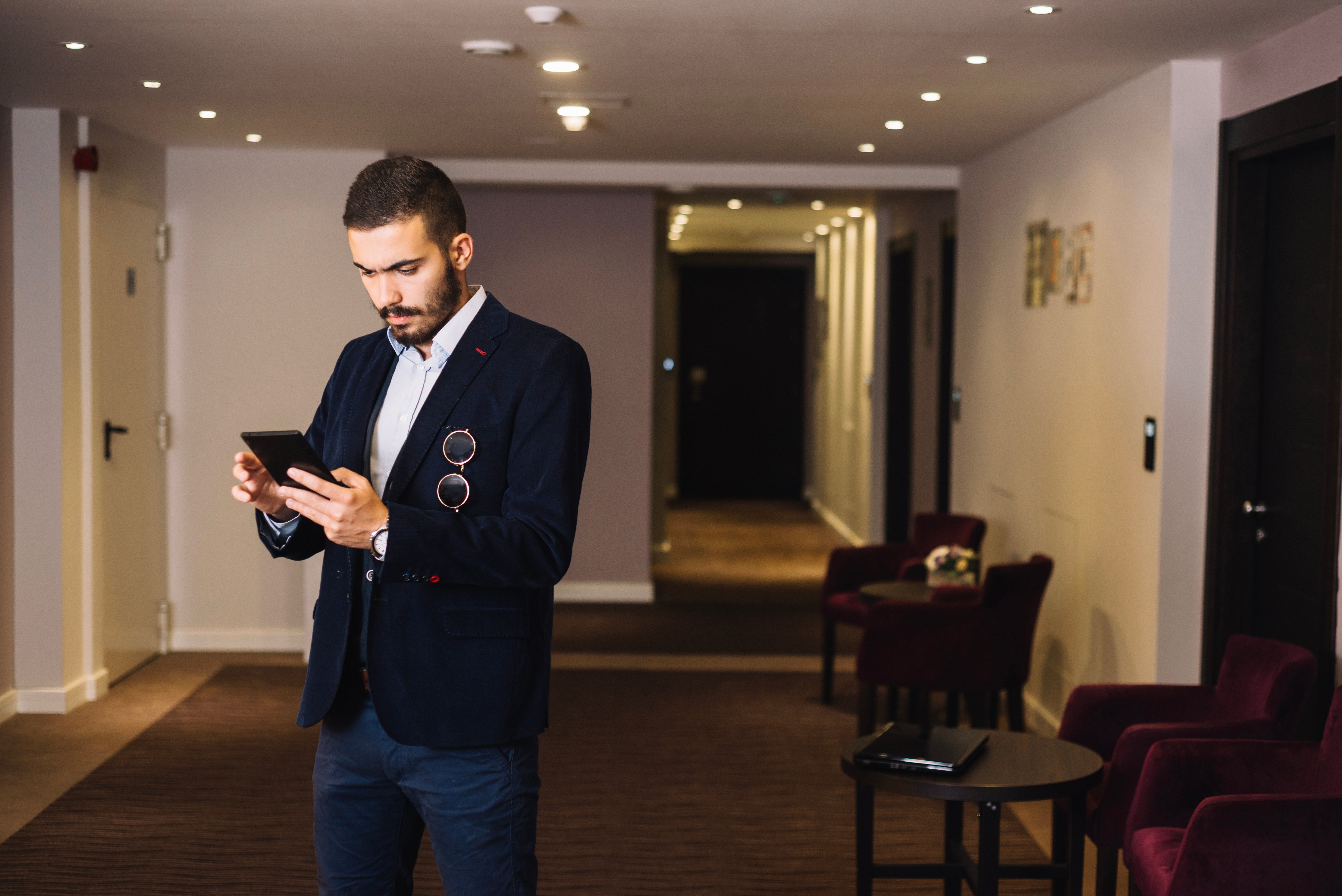 trendy-businessman-hall-with-gadget